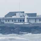 A duotoned blue and white image of Bodega Marine Laboratory and Horseshoe Cove