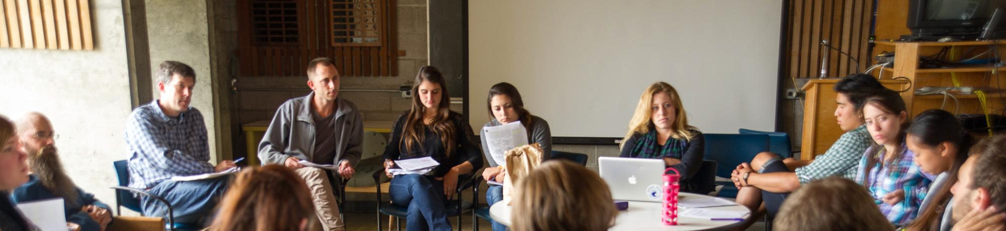 A group of students gathered around in discussion